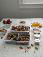 Two lavashak celebration trays with strawberries, mango, nuts and dipping sauces